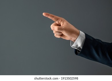 Male hand in suit shows index finger gesture on gray background. Navigator concept, head, close-up - Powered by Shutterstock