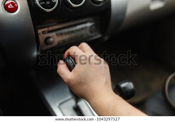 Male hand\
switches automatic transmission closeup. Close up view of gear\
lever manual transmission car interior\
parts.