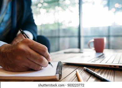 Male hand taking notes on the notepad. Handwriting. Creative writing. Inscription or recording of signs and symbols. - Shutterstock ID 503223772