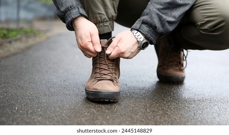 Male hand tie shoelaces on brown shoes closeup background - Powered by Shutterstock