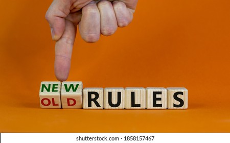Male hand turns cubes and changes words 'old rules' to 'new rules' on a beautifulorange background. Business and covid-19 pandemic concept. Copy space. - Shutterstock ID 1858157467