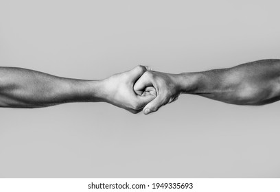 Male Hand United In Handshake. Man Help Hands, Guardianship, Protection. Two Hands, Isolated Arm, Helping Hand Of A Friend. Friendly Handshake, Friends Greeting. Rescue, Helping Hand. Black And White.