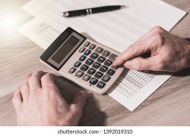Male hand using calculator, accounting concept