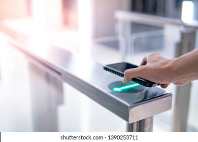 Male Hand Using Smartphone To Open Automatic Gate Machine In Office Building