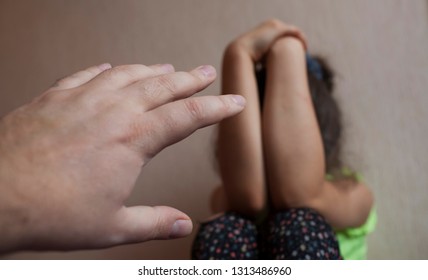 Male hand wants to hit a little girl