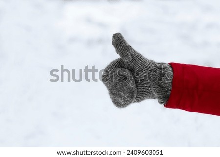 Male hand in warm knitted mitten.Winter love concept.