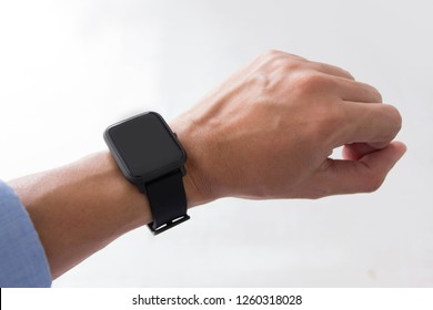 Male Hand Wearing Smart Watch With Blank Screen On White Background