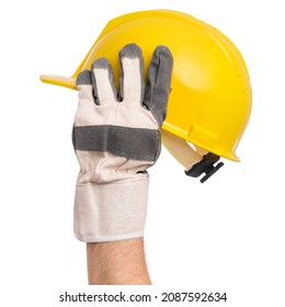 Male Hand Wearing Working Glove Holding Yellow Hard Hat. Gloved Hand Of Professional Repairman With Construction Helmet, Isolated On White Background.