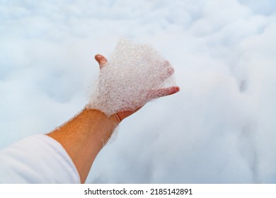 Male Hand With White Foam For Foam Party. Dancing To Music On A Dance Floor Covered With A Few Feet Of Foam Or Bubbles Emitted From The Foaming Agent. Background And Texture.