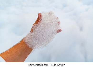 Male Hand With White Foam For Foam Party. Dancing To Music On A Dance Floor Covered With A Few Feet Of Foam Or Bubbles Emitted From The Foaming Agent. Background And Texture.