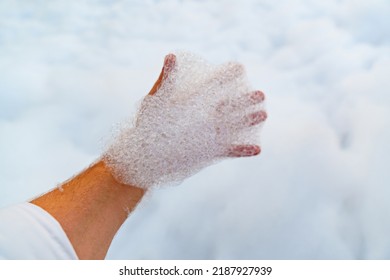 Male Hand With White Foam For Foam Party. Dancing To Music On A Dance Floor Covered With A Few Feet Of Foam Or Bubbles Emitted From The Foaming Agent. Background And Texture.