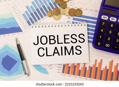 Male Hand Writing Jobless Claims On White Note. Business Concept