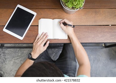 Male Hand Writing In Notebook With Pen