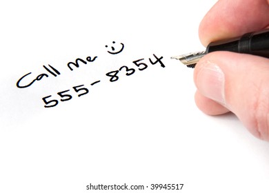 A Male Hand Writing A Phone Number Onto A Note.