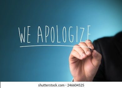 Male hand writing phrase we apologize you on virtual screen.