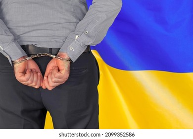 Male With Handcuffs On The Background Of The Ukraine Flag. Back View. Concept Of Prisons And Corruption In Ukraine