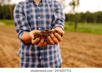 Male hands checking soil health before growth a seed of vegetable or plant seedling. Business or ecology concept. - Powered by Shutterstock