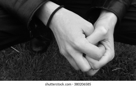 Male Hands Clasped Together Loosly.