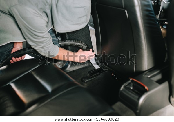 Male hands\
cleans car interior on carwash\
station