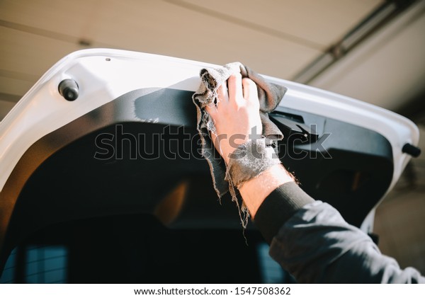 Male hands\
cleans car interior on carwash\
station