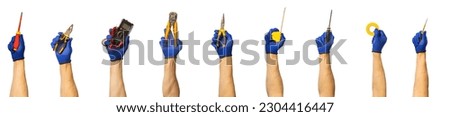 Male hands with different tools of an electrician on a white background. Screwdrivers, pliers, multimeter, automatic insulation stripper, Long nose pliers, tape measure, tape and electrical tester.