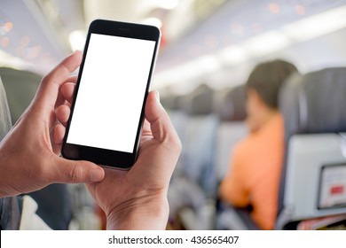 Male hands holding blank screen mobile in airplane.mockup template