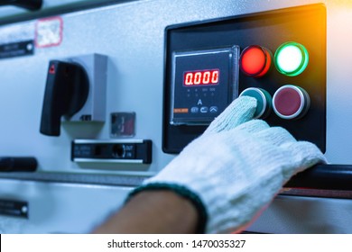 Male Hands Holding The Control Panel Of The Industrial Plant And Pushing The Button In Electrical Selector Switch,button Switch,Electrical Switch Gear At Low Voltage Motor Control Center Cabinet .