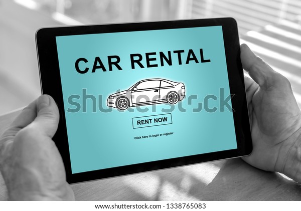 Male hands\
holding a tablet with car rental\
concept