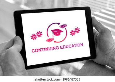 Male Hands Holding A Tablet With Continuing Education Concept