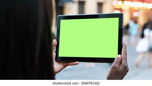 Male Hands Holding Tablet With Green Screen. Guy Using Mobile Phone While Walking In The Autumn Street. Back View Shot. Chroma Key, Close Up Man Hand Holding Device With Green Screen 