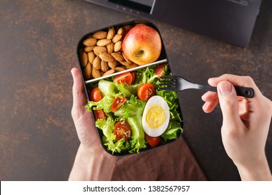 Male Hands Holding Takeaway Lunch Box With Healthy Food. Lunch Break At Office.