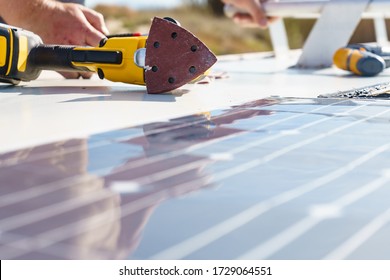 Male Hands Installing Flexible Solar Panel On Rv Campervan Or Repair Camper Car Roof.