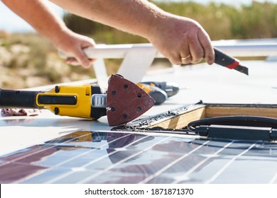 Male Hands Installing Flexible Solar Panel On Rv Campervan Or Repair Camper Car Roof.