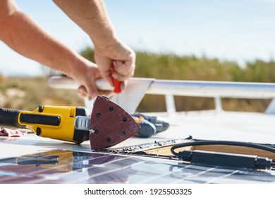 Male Hands Installing Flexible Solar Panel On Rv Campervan Or Repair Camper Car Roof.