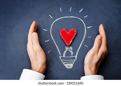 male hands involves drawing light bulb on chalkboard. toning. selective Focus
