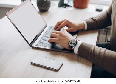 Male Hands On Laptop Keyboard. A Laptop With A Clean White Screen And Blank Space For Text. Side View