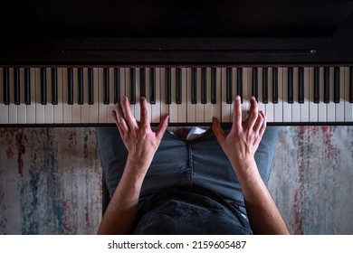 Male Hands On The Piano Keys, Top View.