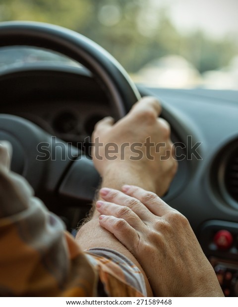 male hands on steering wheel\
