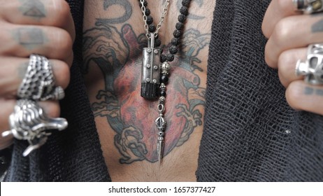 Male Hands Open A Heart-shaped Tattoo On The Chest