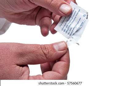 Male Hands Opening Alcohol Swab For Medical Use Isolated On White