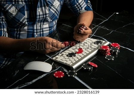 Male hands with poker chips near the keyboard. online casino. Online gambling. Poker online.