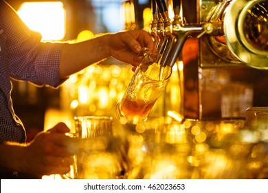 Male hands poured beer from the tap