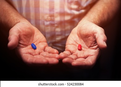 Male Hands With Red And Blue Pills, Closeup