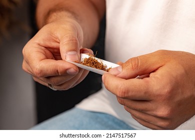 Male Hands Rolling Tobacco In Cigarette Paper