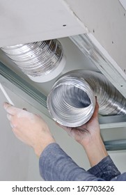 Male hands setting up ventilation system indoors