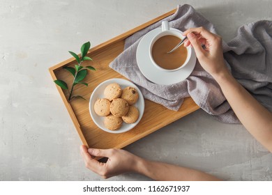 Male Hands Stir Cup Of Coffee With Milk And Cookies On Tray.