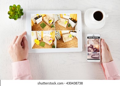 Male Hands With Tablet And Phone On White Table. Home Security System Concept