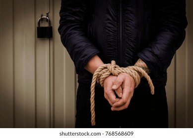 Male Hands Tied With A Rope.