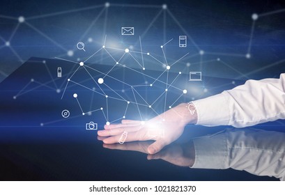 Male hands touching interactive table with blue mixed communication icons in the background - Shutterstock ID 1021821370