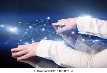 Male hands touching interactive table with blue connectivity graphic in the background - Shutterstock ID 654869443